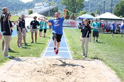Jon Adkins, long jump;  looking on  SSU Physical Therapy students