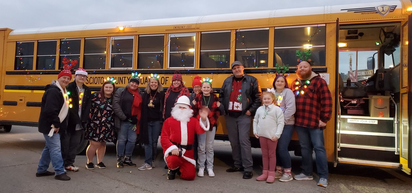 people standing outside with bus